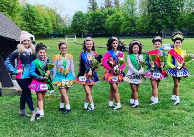 A group of Irish dancers holding their trophies